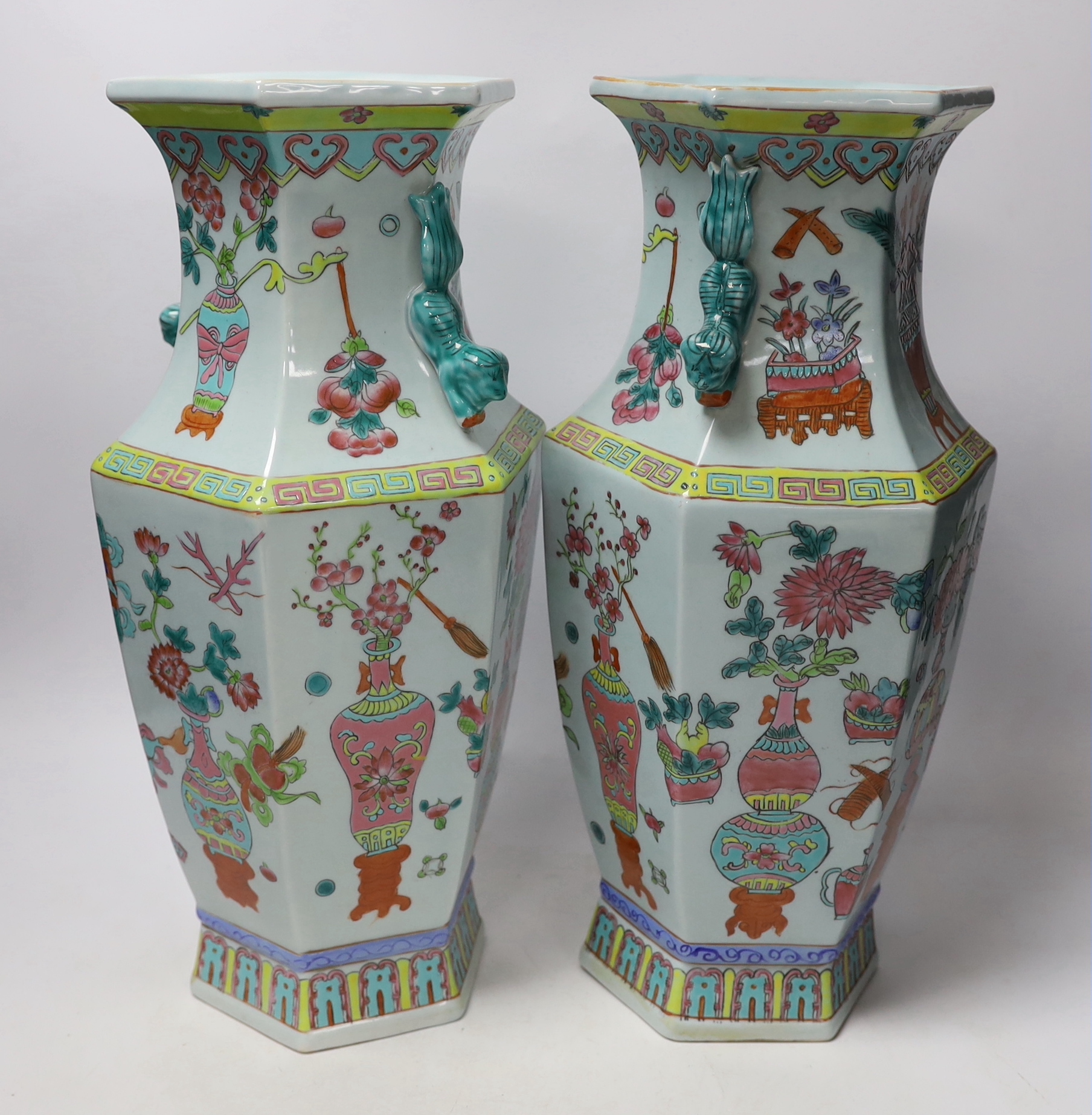 A pair of Chinese famille rose vases and a similar jar and cover, 38cm